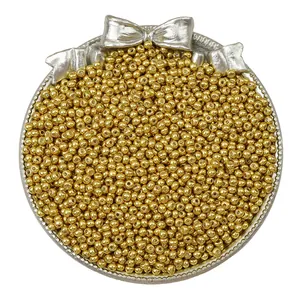 Polished metallic gold glass seed beads for DIY jewelry making in a decorative tray