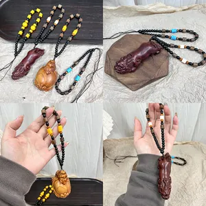 Collar de madera con colgante de criatura mítica, cuentas de colores y cordón trenzado