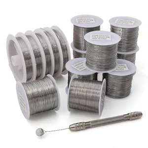 Detail of stainless steel jewelry wire spools with bead drilling tool for DIY crafting