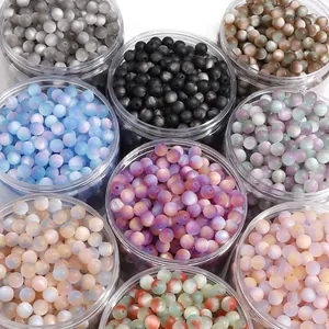 Close-up of 8mm matte resin cat eye beads in various colors stored in clear jars