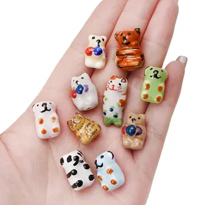 Hand-painted ceramic animal beads featuring pandas and cats for DIY jewelry making
