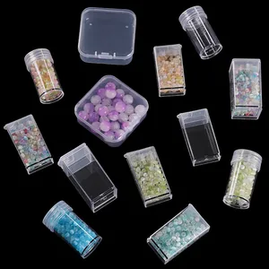 Macro shot of transparent plastic containers for beads and jewelry on black background
