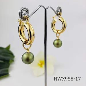 Detail of 18K gold hoop earring featuring a deep green pearl on a T-bar display stand