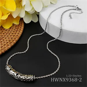 Detailed close-up of engraved hollow tube pendant with 22+3 inch twisted chain