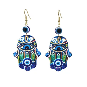 Detailed view of Hamsa hand earrings with colorful Evil Eye patterns and drop design