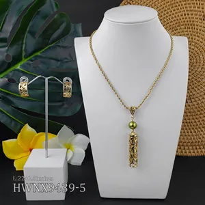 Close-up of golden tropical jewelry set with hollow details and 22+2.5 inch necklace