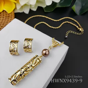 Detail of tropical gold hollow turtle pendant and matching earrings with dark pearls