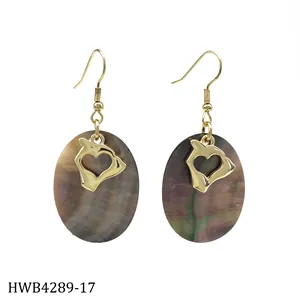 Detail of oval black shell earrings with gold Hawaii Oahu island outline and heart cutout
