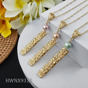 Detailed view of floral engraved gold bar necklaces with pink, champagne and green pearls