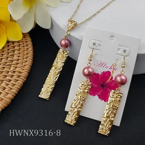 Detail of tropical frangipani jewelry set with engraved gold bars and purple pearls