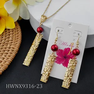 Detailed view of Hawaiian frangipani jewelry set with red pearls and gold floral engraving