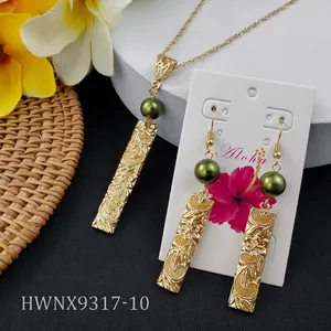 Detailed view of Hawaiian plumeria jewelry set with green pearl and Aloha display card