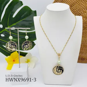 Detail of gold necklace set with green pearl and black enamel spiral wave design