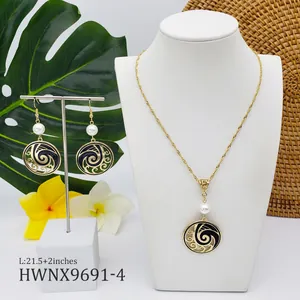 Detail of Hawaii style jewelry set with gold rope chain and black wave pattern pendants