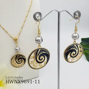 Detailed view of Hawaiian wave jewelry set with black enamel and natural pearls