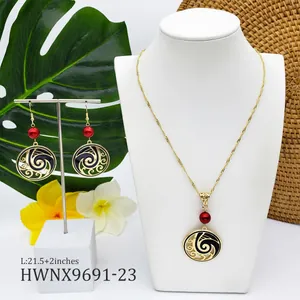 Detail view of wave-pattern necklace and earrings set with red pearls on a white display