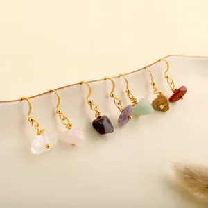 Detailed display of assorted natural crystal drop earrings on a white ceramic plate