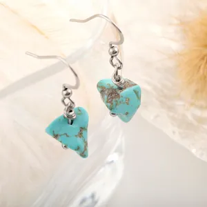 Detailed close-up of natural turquoise earrings with silver stainless steel hooks