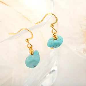 Detail of natural turquoise raw stone earrings with gold stainless steel hooks