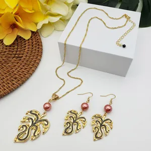 Detail of Monstera leaf jewelry set with pink pearls and gold alloy tropical necklace