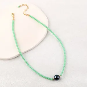 Minimalist light green faceted crystal bead choker necklace with a purple metallic pearl bead
