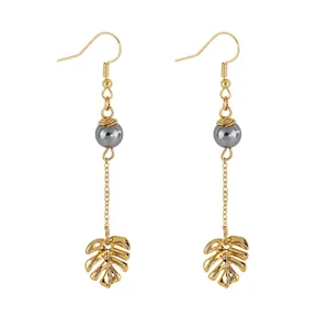 Minimalist gold monstera leaf earrings with mother of pearl beads and long chain drop