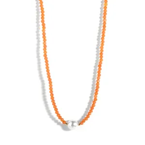 Close-up of orange crystal beaded choker featuring a single white pearl centerpiece