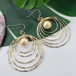 Elegant gold multi-layered circular drop earrings featuring a champagne pearl center detail