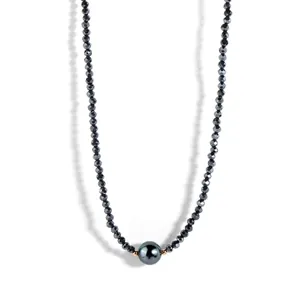 Detail of beaded choker with faceted black beads and a large grey pearl center