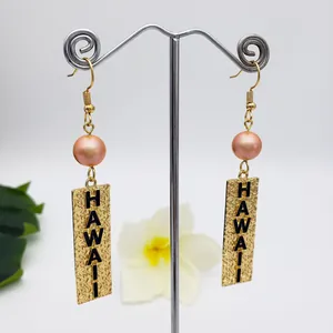 Hawaii style gold drop earrings with pink pearl accents and textured HAWAII metal plates