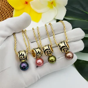 Detailed shot of golden necklaces with colorful pearls and black enamel ethnic patterns