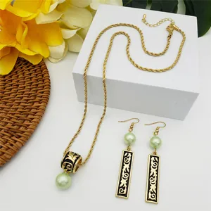 Polynesian totem jewelry set with black enamel pendant and green faux pearl beads