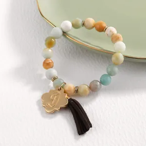 Natural gemstone beaded bracelet with gold flower letter D pendant and brown tassel detail