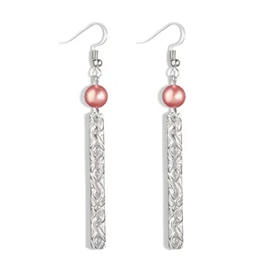 Detailed view of silver long bar earrings with pink pearls and floral engravings