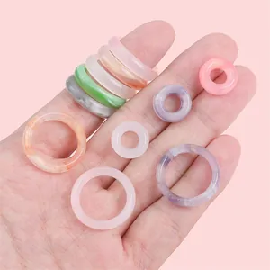 Mix of colorful acetate acrylic rings and marble pattern beads for DIY jewelry making
