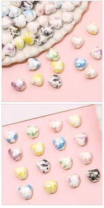 Macro view of colorful heart-shaped ceramic beads with iridescent finish for DIY jewelry