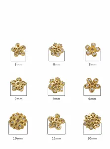 Macro view of 14K gold plated cubic zirconia floral and snowflake jewelry beads
