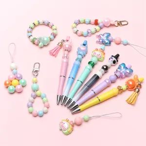 Close-up of DIY bead pens with cute animal charms and colorful macaron tassels