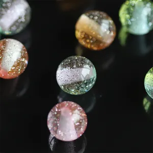 Macro view of translucent resin beads with shimmering glitter for DIY jewelry making