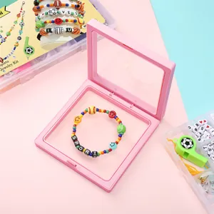 Pink PE film jewelry display box showcasing a colorful sports themed DIY beaded bracelet