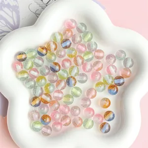 Colorful resin beads with fine glitter and rainbow stripes in a star-shaped tray