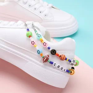 DIY sports-themed bead charms with soccer and basketball on white sneakers