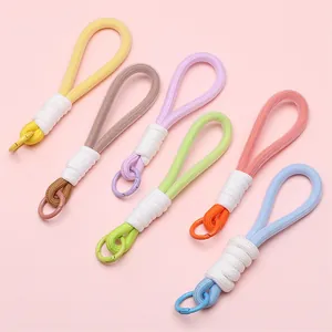 Detail showing 6 colors of woven keychain straps with metallic round clasps in macro view