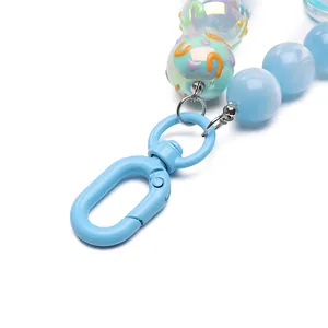 Sky blue beaded keychain with alloy spring buckle and decorative patterned round beads