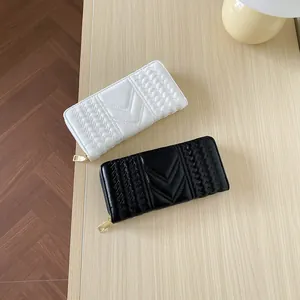 Quilted long wallets for women with V-stitch embroidery and gold zipper in black and white