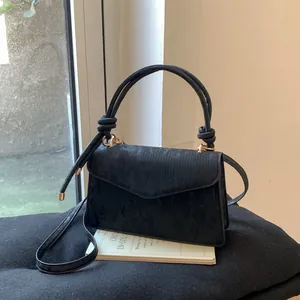 Chic black velvet crossbody bag with envelope flap and knotted handle detail