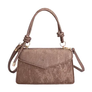 Chic Maillard brown textured crossbody bag with vertical stripes and golden hardware