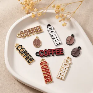 Macro shot of colorful enamel coffee pendants and bean charms in a white ceramic dish