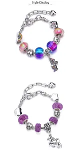 Detail of colorful rainbow unicorn beaded charm bracelets with snake chain and heart clasp