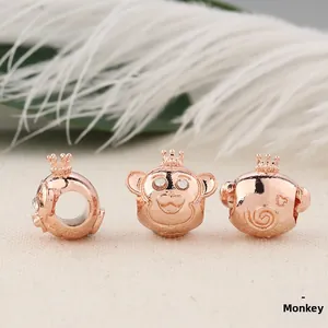 Detailed macro view of rose gold monkey charms with crown and crystal eyes for DIY bracelets